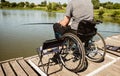 Young disabled man in a wheelchair fishing. Royalty Free Stock Photo