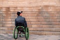 young disabled man in wheelchair in front of stairs Royalty Free Stock Photo
