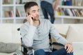 Young disabled man on phone at home