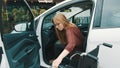 Young disabled woman getting out of the car in the wheelchair Royalty Free Stock Photo