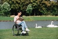 Young disabled woman reading book while Royalty Free Stock Photo