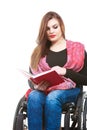 Young disabled woman in wheelchair with book. Royalty Free Stock Photo