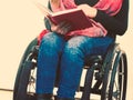 Young disabled woman in wheelchair with book. Royalty Free Stock Photo