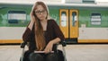 Young disabled woman in the wheelchair lost the train