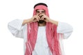 Young disappointed Arab with a checkered veiland holding his head