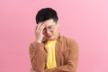 Young disappointed man holding his head isolated on pink background Royalty Free Stock Photo