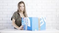 A young girl opens up a blue box gift Royalty Free Stock Photo