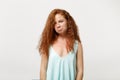 Young displeased offended redhead woman in casual light clothes posing isolated on white background, studio portrait