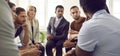 Team of serious young diverse business people discussing something in work meeting Royalty Free Stock Photo