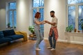 Young diverse couple in love preparing first wedding dance together at home Royalty Free Stock Photo