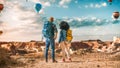 Young Diverse Tourist Couple Hiking with Backpacks in Great Wilderness in Rocky Canyon Valley. Male Royalty Free Stock Photo