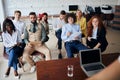 Young diversity team of employees listening to business coach on training in office Royalty Free Stock Photo