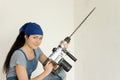 Young DIY woman holding an electric drill Royalty Free Stock Photo