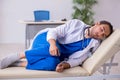 Young male doctor being tired after night shift Royalty Free Stock Photo