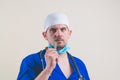 Young doctor in blue suit with spatula in his hand Royalty Free Stock Photo