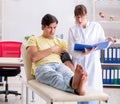 Young doctor checking patients blood pressure Royalty Free Stock Photo