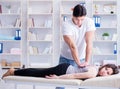 Young doctor chiropractor massaging female patient woman Royalty Free Stock Photo