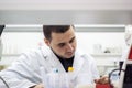 Young doctor conducts research, and it is very concentrated and