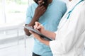 Young doctor consulting African-American patient Royalty Free Stock Photo