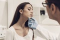 Young Doctor Consulting Beautiful Woman in Clinic.