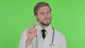 Young Doctor in Denial on Green Background