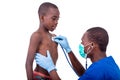 Young doctor examining little boy by stethoscope Royalty Free Stock Photo