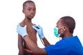 Young doctor examining little boy by stethoscope Royalty Free Stock Photo