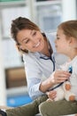 Young doctor examining little girl with stethoscope Royalty Free Stock Photo