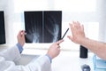 Young doctor examining x-ray of hands of a senior patient with arthritis Royalty Free Stock Photo