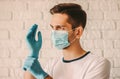 Young doctor in face mask wearing medical gloves Royalty Free Stock Photo