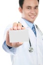 Young doctor holding business blank card