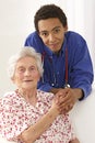 Young Doctor holding elderly lady's hands at home Royalty Free Stock Photo