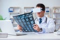 The young doctor looking at mri scan through vr glasses Royalty Free Stock Photo