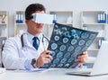 Young doctor looking at MRI scan through VR glasses Royalty Free Stock Photo