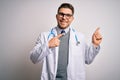 Young doctor man with blue eyes wearing medical coat and stethoscope over isolated background smiling and looking at the camera Royalty Free Stock Photo