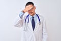 Young doctor man wearing stethoscope over isolated background covering eyes with hand, looking serious and sad Royalty Free Stock Photo