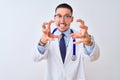 Young doctor man wearing stethoscope over isolated background Shouting frustrated with rage, hands trying to strangle, yelling mad