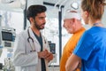 Young doctor and nurse consulting health condition with senior man. Royalty Free Stock Photo