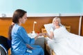 Young doctor or nurse in uniform is giving pills to her patient Royalty Free Stock Photo