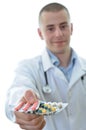 Young doctor offering many drugs isolated