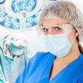 Young doctor in operation room with surgeon on background Royalty Free Stock Photo