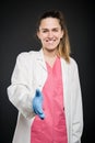 Young doctor portrait wearing robe offering hand shake Royalty Free Stock Photo