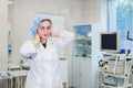 Young doctor during preparation for operation. Assistant of surgeon wearing medical cap in operation room at the Royalty Free Stock Photo