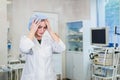 Young doctor during preparation for operation. Assistant of surgeon wearing medical cap in operation room at the Royalty Free Stock Photo