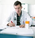 Young doctor prescribing recipe Royalty Free Stock Photo