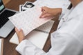 doctor cardiologist hands close up examines cardiogram drawing sitting at table with computer