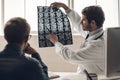 Young Doctor Showing MRI Scan of Brain to Patient Royalty Free Stock Photo