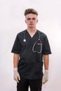 Young doctor with stethoscope in dark medical uniform posing isolated on white Royalty Free Stock Photo