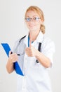 Young doctor with stethoscope giving thumbs up