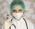 Young doctor with a syringe preparing to inject Royalty Free Stock Photo